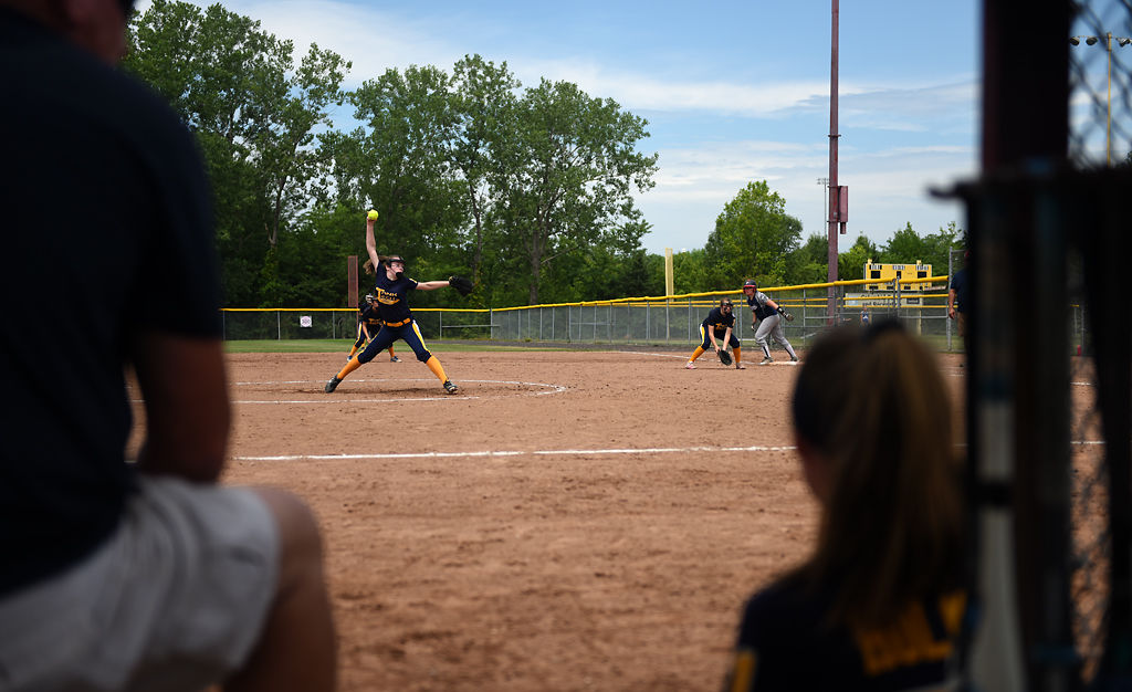 Tank Tech Softball coach Mike Riley and player Kayleigh Holman, 13, watch from the dugout